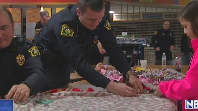 Officers make blankets for the community during the holidays