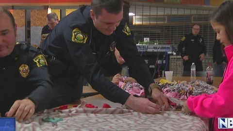 Officers make blankets for the community during the holidays