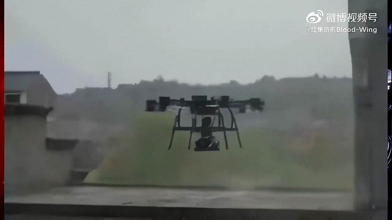 Drone transports robot dog armed with machine gun