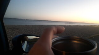 Coffee time in a car . Sunset.