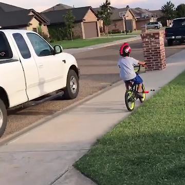 Boy Rides Bike Across Street and Runs into Brick Post