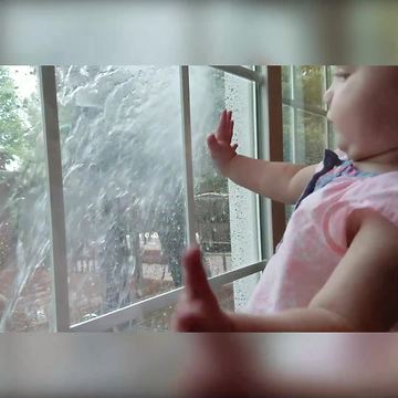 Tot Girl Gets Startled When Her Dad Sprays Window She Stares Out