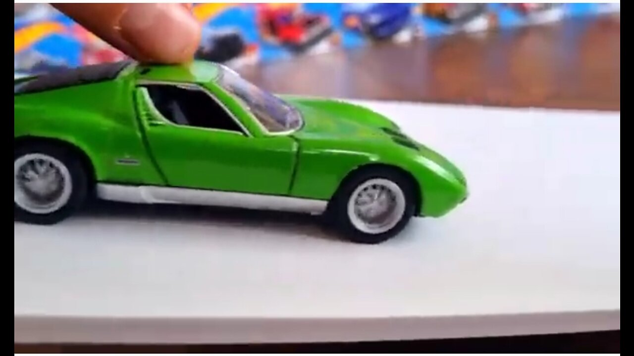 various diecast model cars moving donw one the slope