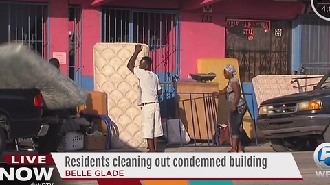 Residents cleaning out condemned building in Belle Glade