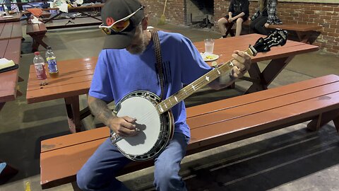 Travis picking banjo after service. 8/20/23