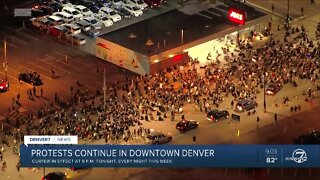 Protesters hold moment of silence for George Floyd on Broadway and Welton Street in downtown Denver