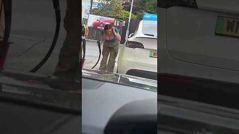 Woman trying to put gas in a Tesla