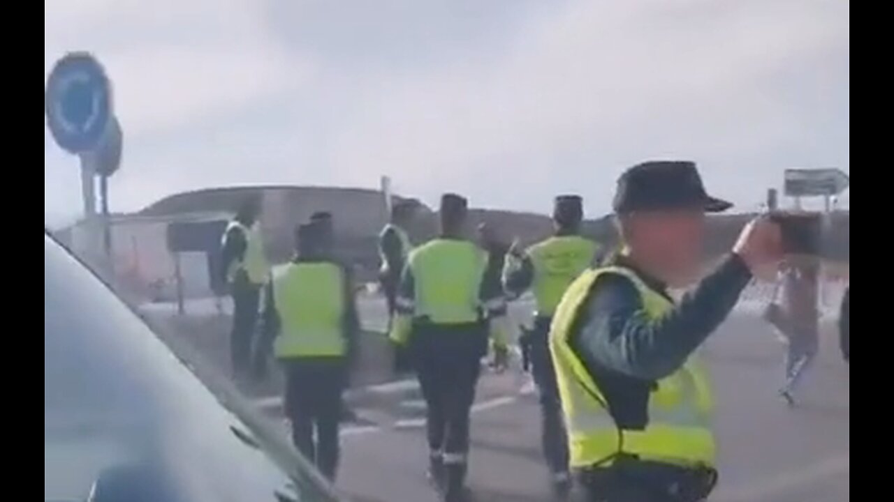 Spain - Police set up roadblock to stop farmers so the farmers drive through the fields