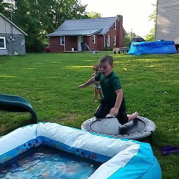 Young Boy Trips And Falls On His Face In A Kiddie Pool