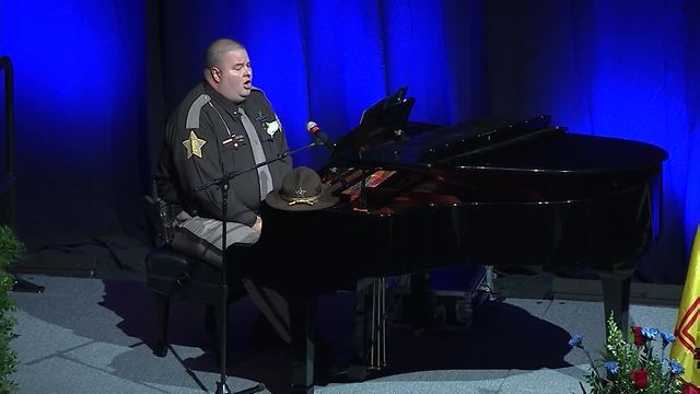 Marion County Lt. Bryan Wolfe performs "Amazing Grace: The Policeman's Tribute" at Lt. Aaron Allan's funeral