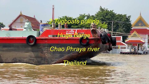 2 Tugboats pulling a huge Barge at Chao Phraya river in Thailand