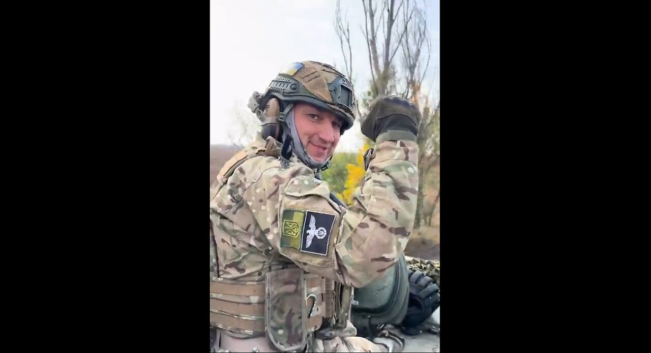 Ukrainian tank crew member shows of his Nazi patch