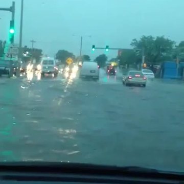 Drivers try to pass through flooded roads in