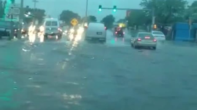 Drivers try to pass through flooded roads in