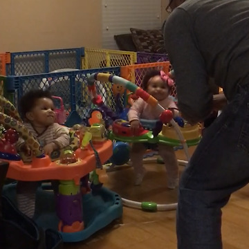 Two Cute Girls Bouncing With Their Dad