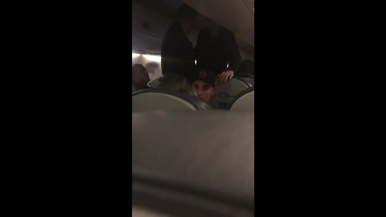 Fellow passenger helps woman during flight