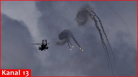 Israeli military helicopter seen over southern Lebanon as smoke plumes along the border