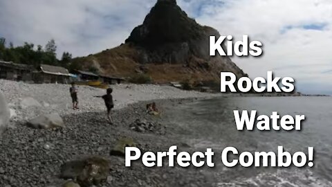 kids playing on rocky beach in Philippines