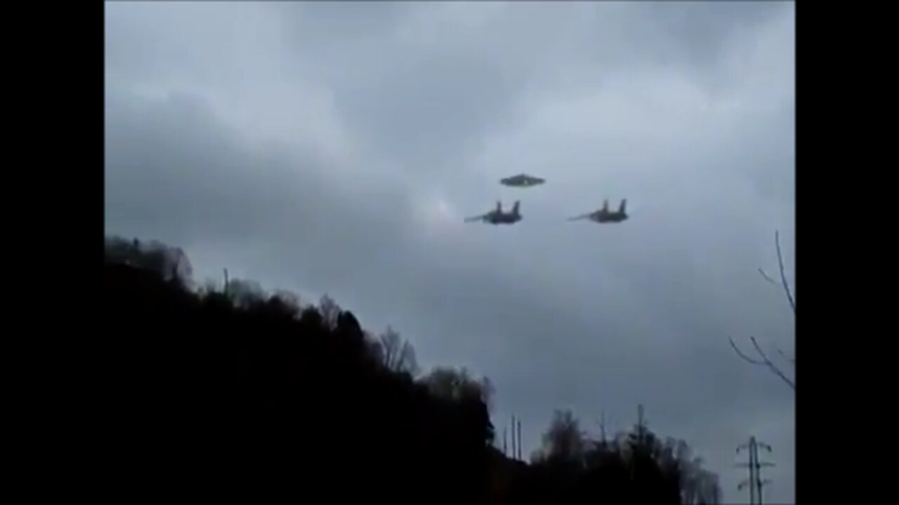 Two F-15 Eagles escort a disc with clearance lights