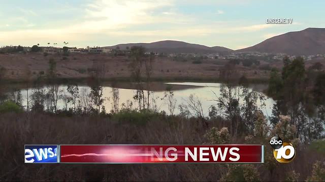 Divers search water for possible body