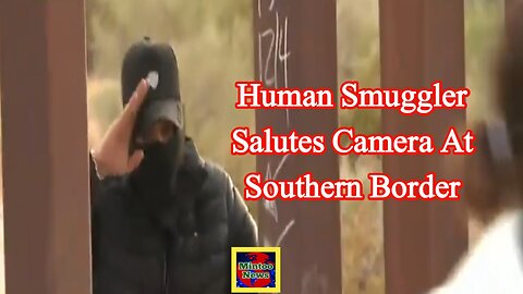 Human smuggler salutes camera at southern border
