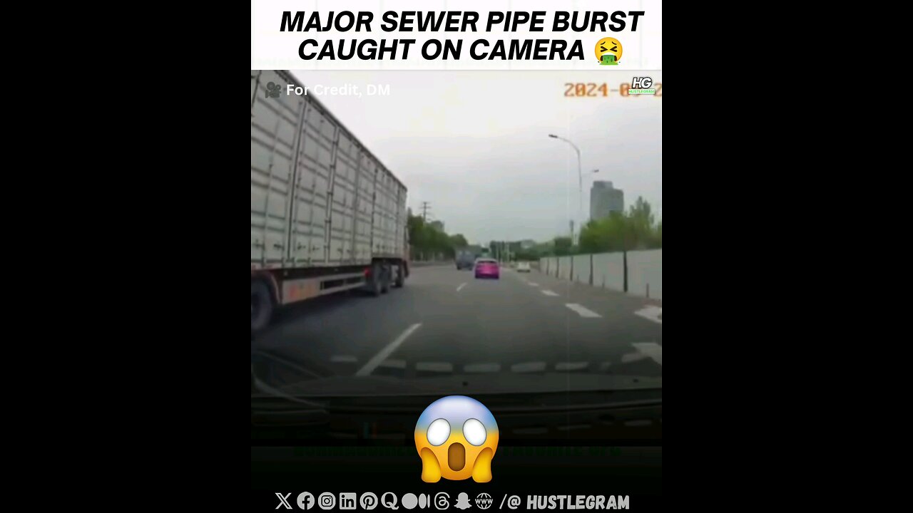 Major sewer pipe burst caught on CCTV camera while people are driving by. For credit, DM