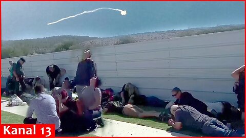 Mourners in northern Israel lie on ground at a cemetery to hide from rockets launched from Lebanon