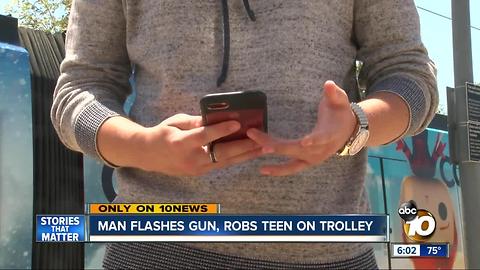 Man flashes gun, robs teen on trolley