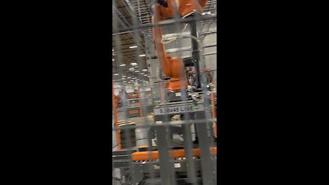 Robotic arm loading ammunition.