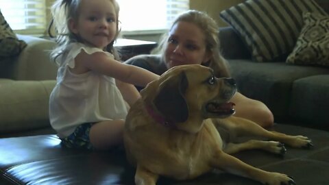 mom and toddler sitting on an ottoman talking