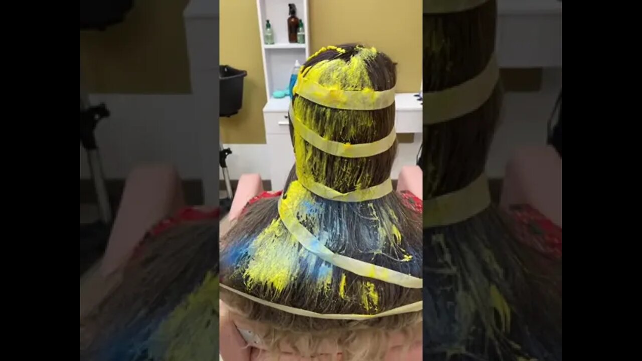 barber creates hairdo using tape…