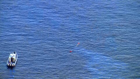 Aerial view shows helicopter submerged in Tampa Bay after crash