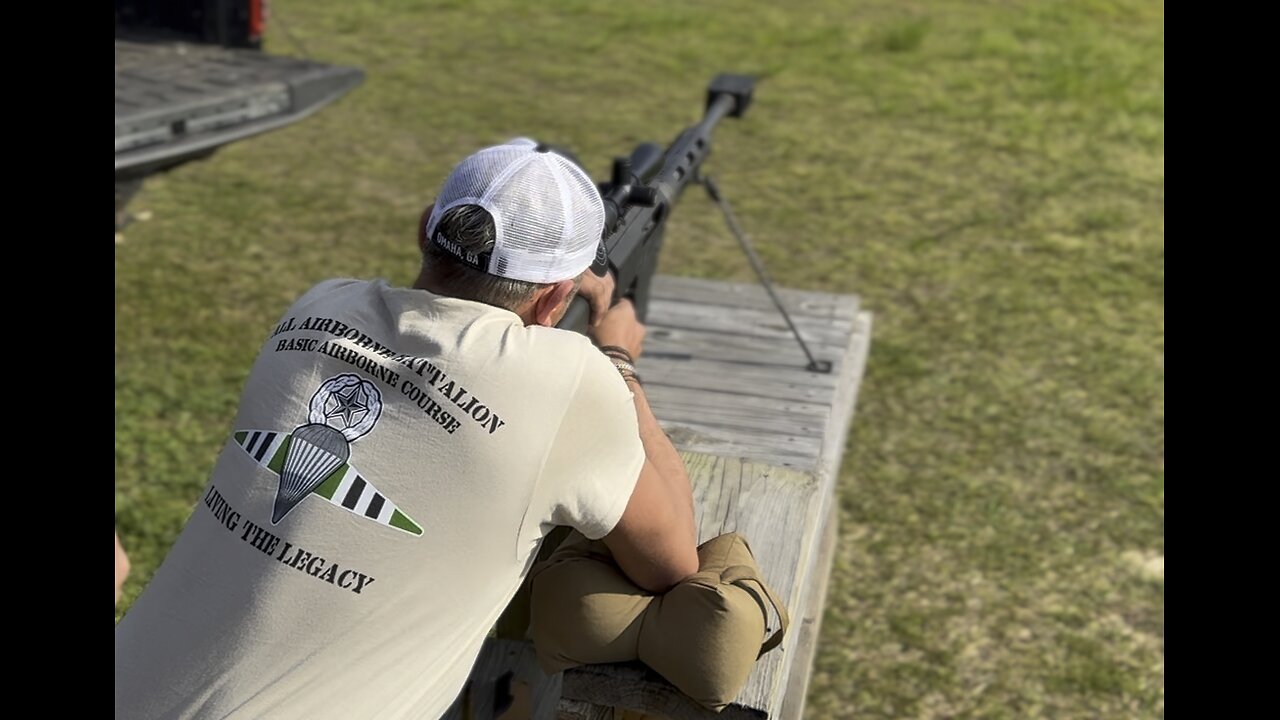 (British) Band of Brothers actor Nolan Hemmings tries his hand at a .50 cal sniper rifle.