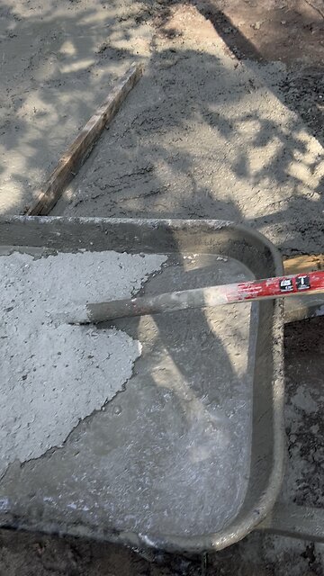 Mixing concrete new dog kennel