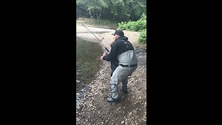 Father son reel in river monster