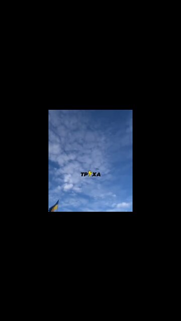 A Kalibr missile flies over a Ukrainian flag towards Lviv