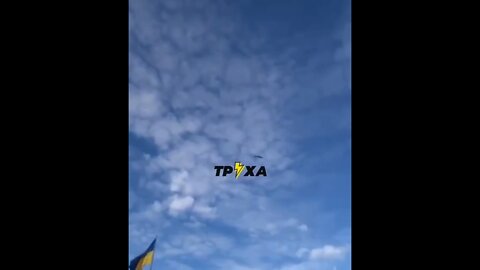 A Kalibr missile flies over a Ukrainian flag towards Lviv