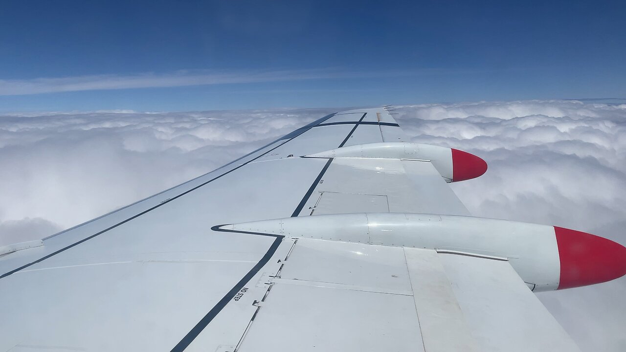 Qantas Fokker 100 descending into clouds