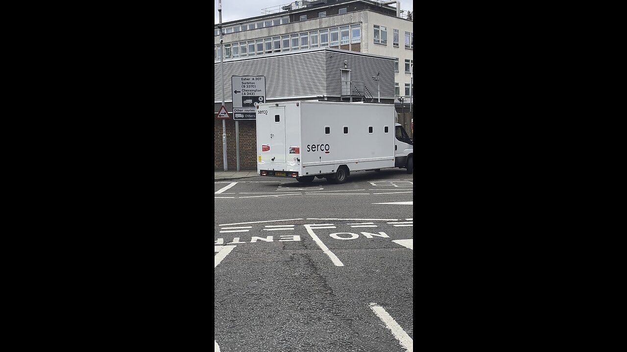 Looks like some baddy is being escorted out of Kingston police station.