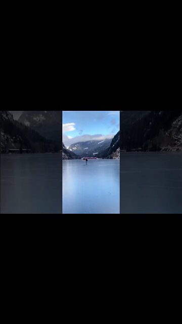 Man Travels Frozen Lake With Umbrella