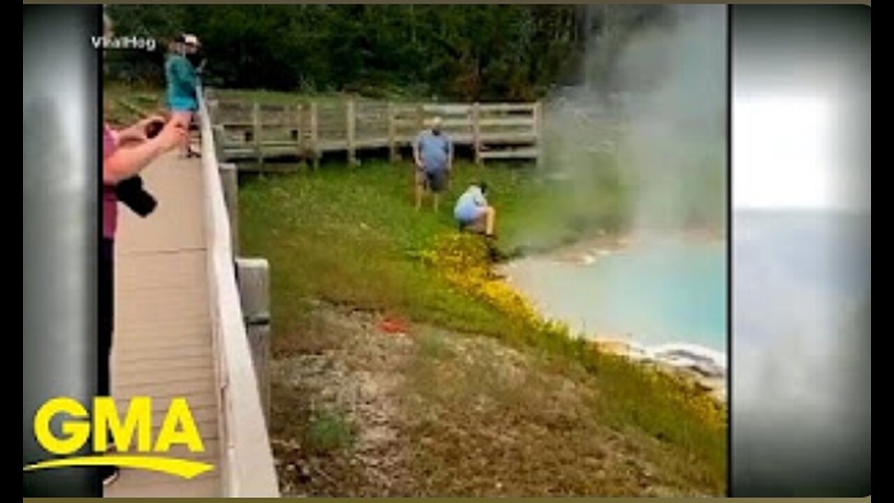 Tourist touches spring hot water with hands