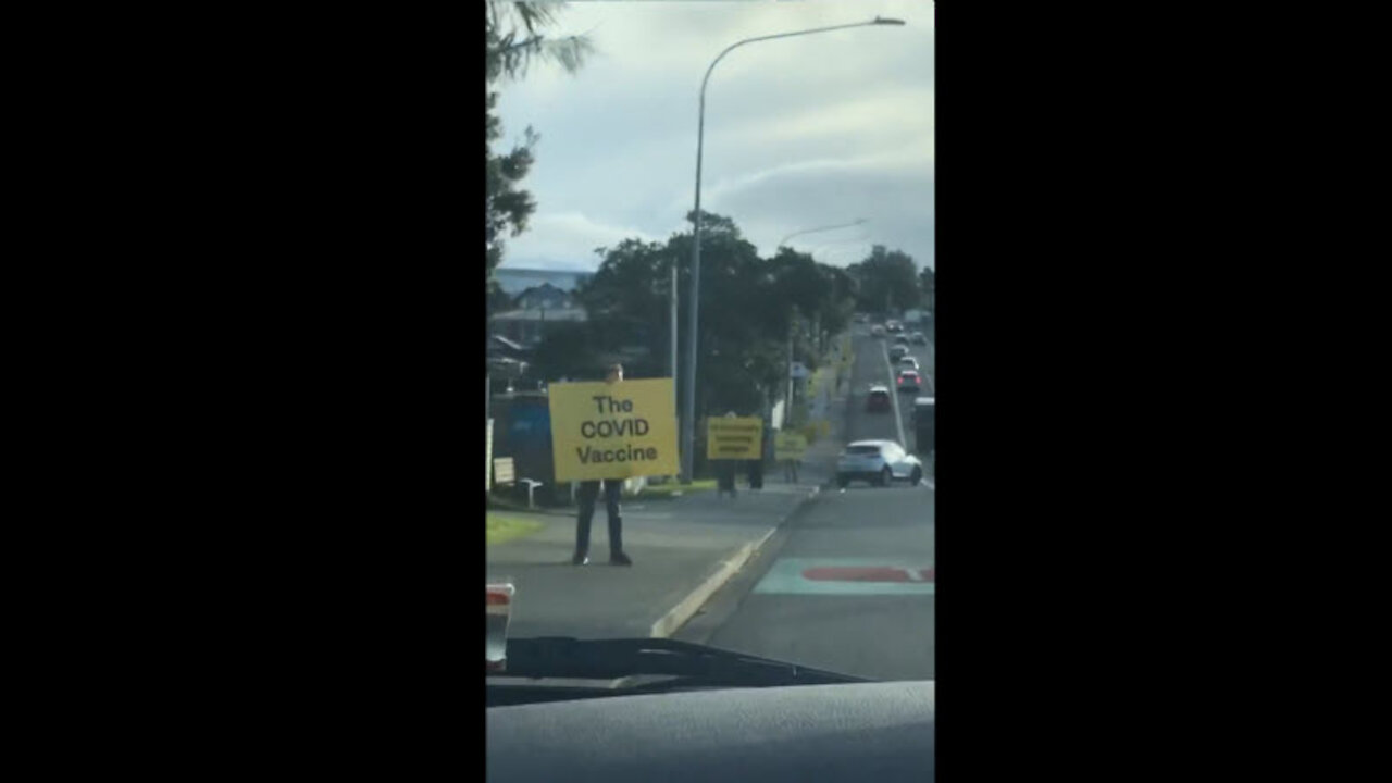 Auckland, New Zealand: People holding warning signs against COVID "vaccination"