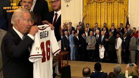 WH visitors instruct Biden to hold his jersey up for the photo.