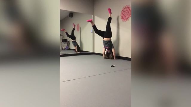 "A Girl Tries to Do A Handstand, But Falls Back Down"