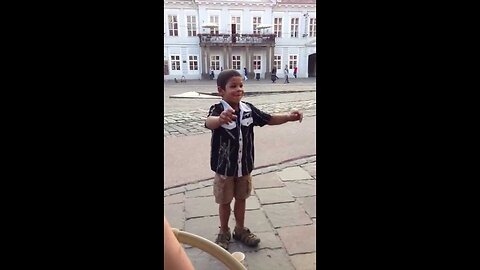 A gypsy boy dances for euros