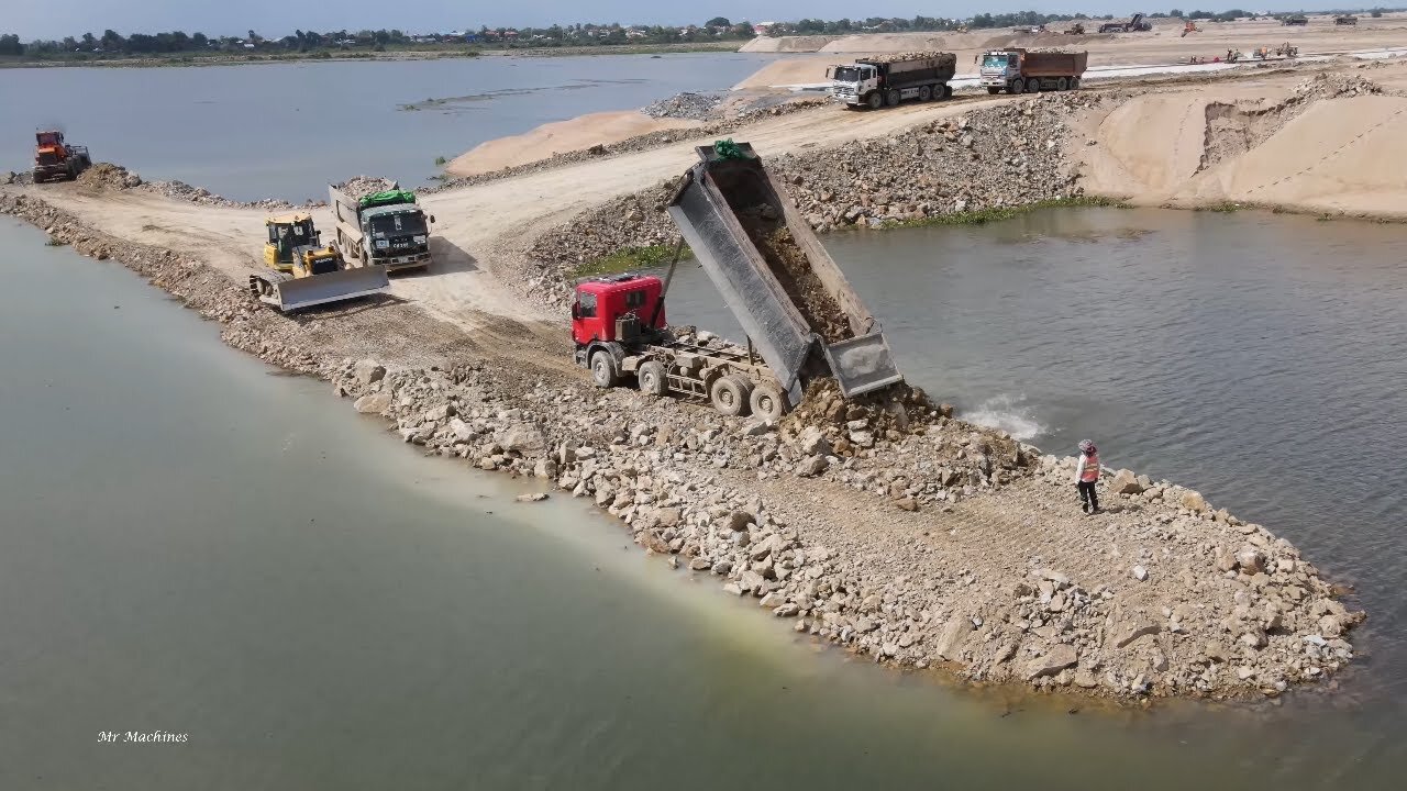 The amazing power of Mighty machines building a new road across a large lake.