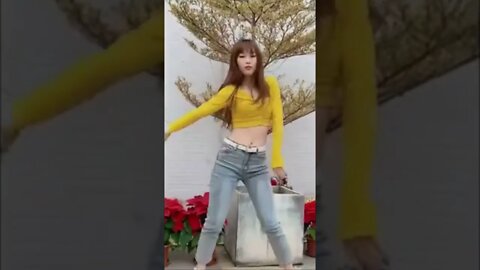 Beautiful Chinese Girl Dances In Front Of A Christmas Tree