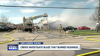 Crews investigate blaze that burned business