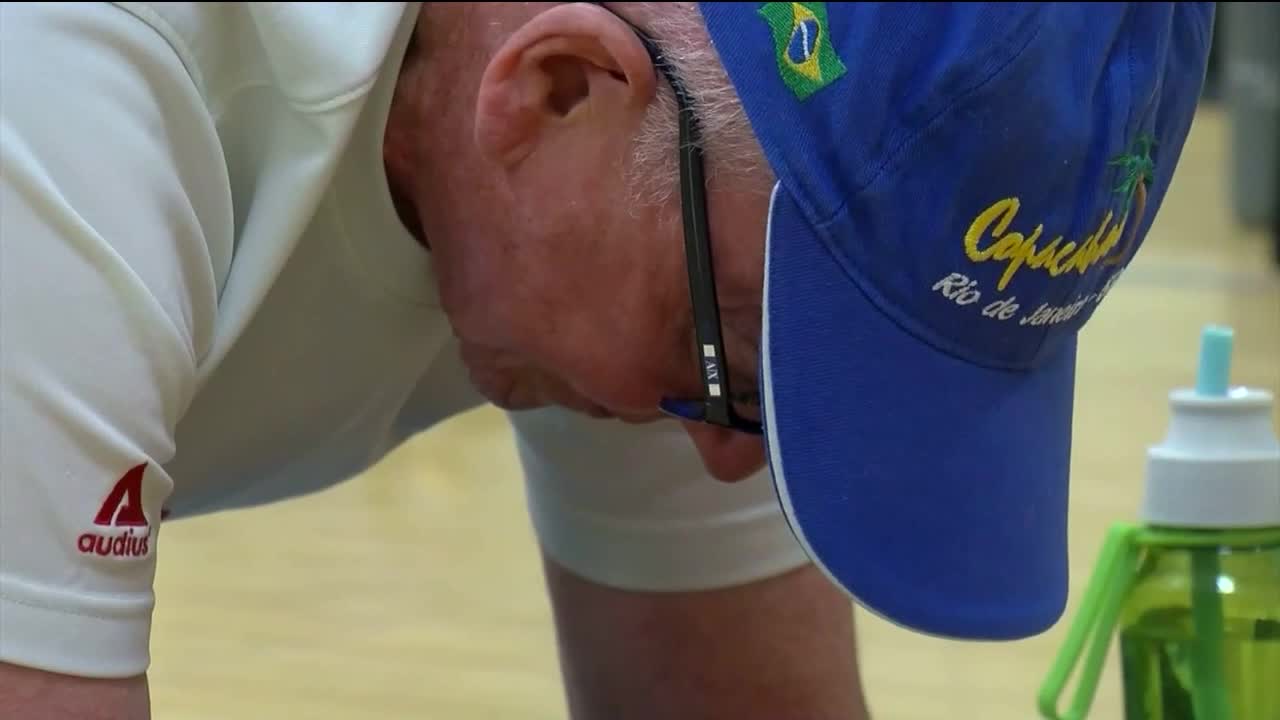 Trent Magill tries to out plank a 71-year-old man