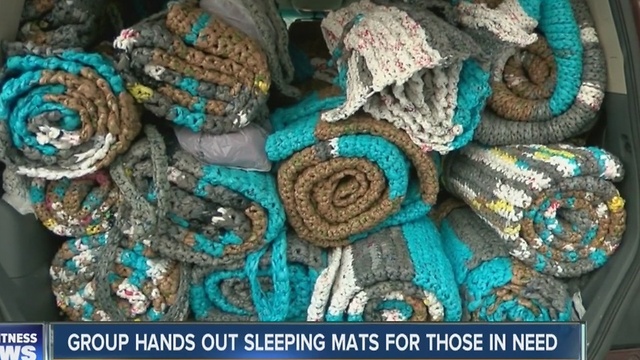 Group hands out sleeping mats for those in need